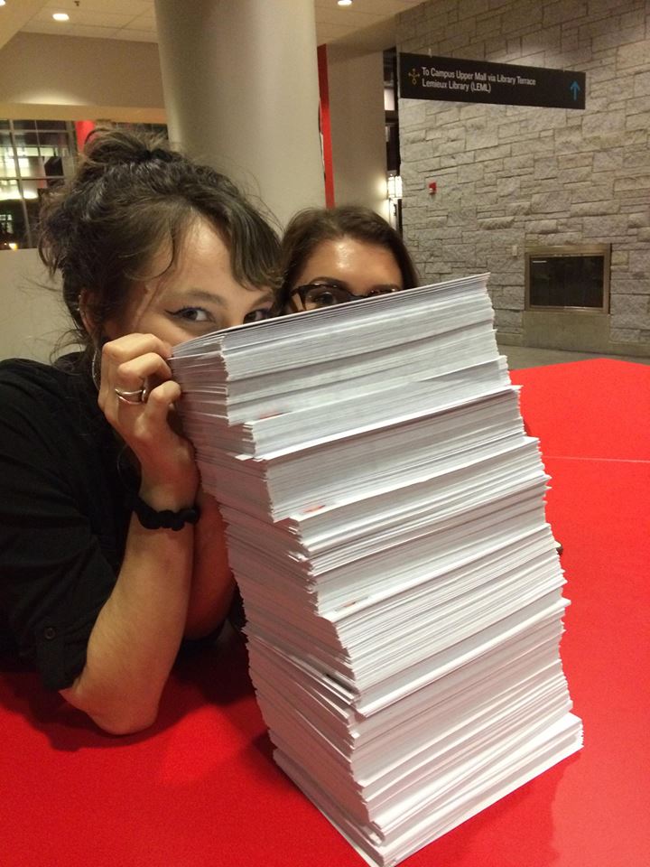 HHAD Campus Event_Madison and Tess peeking over postcards